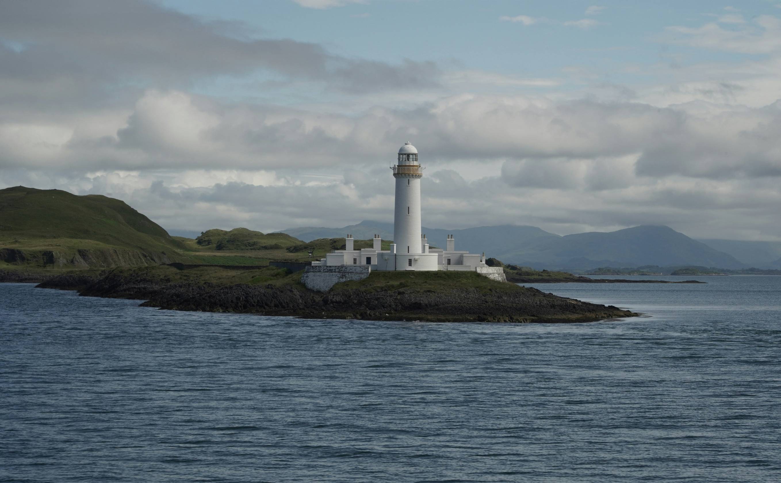 A lighthouse on an island in the middle of the ocean