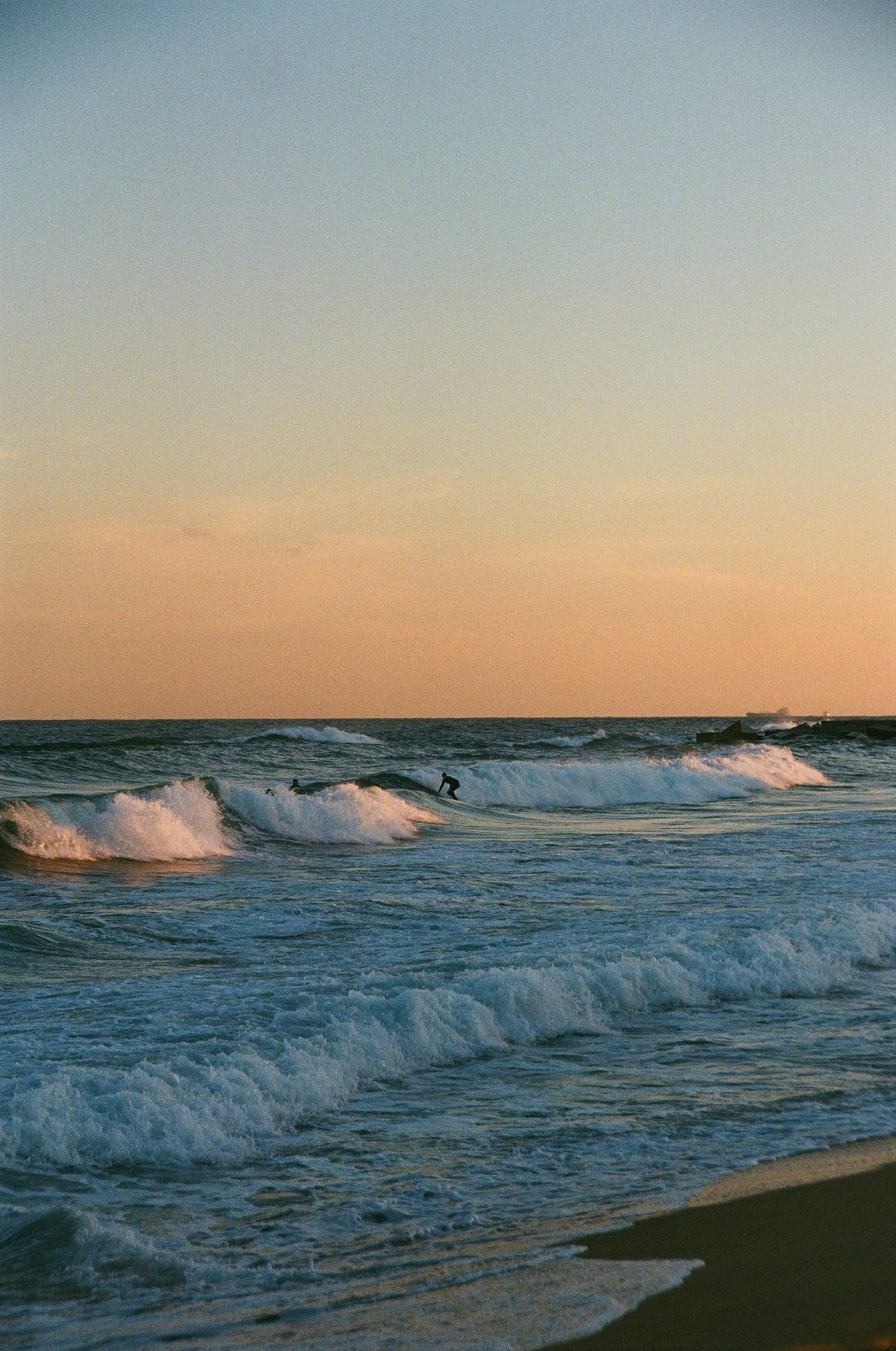 a person riding a surfboard on a wave in the ocean