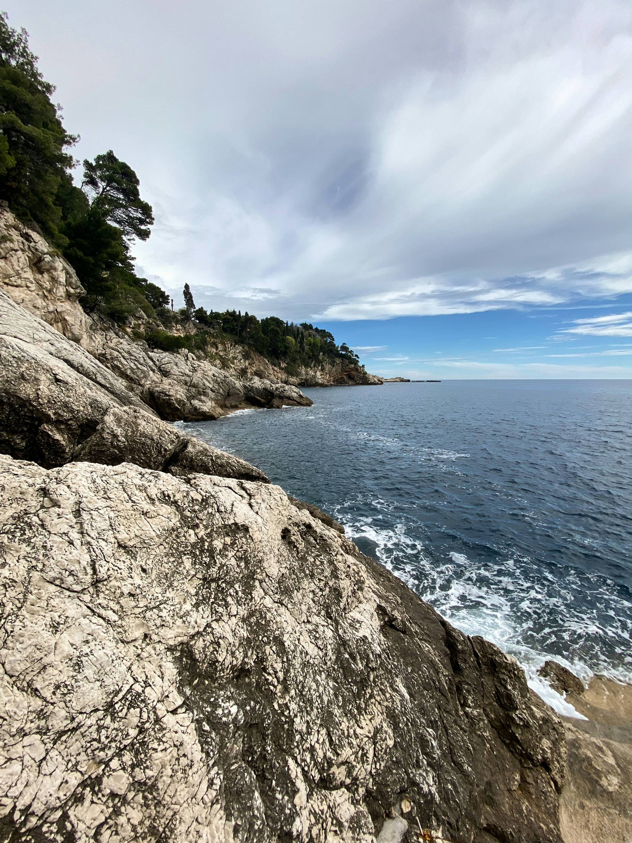 a view of the ocean from a rocky cliff