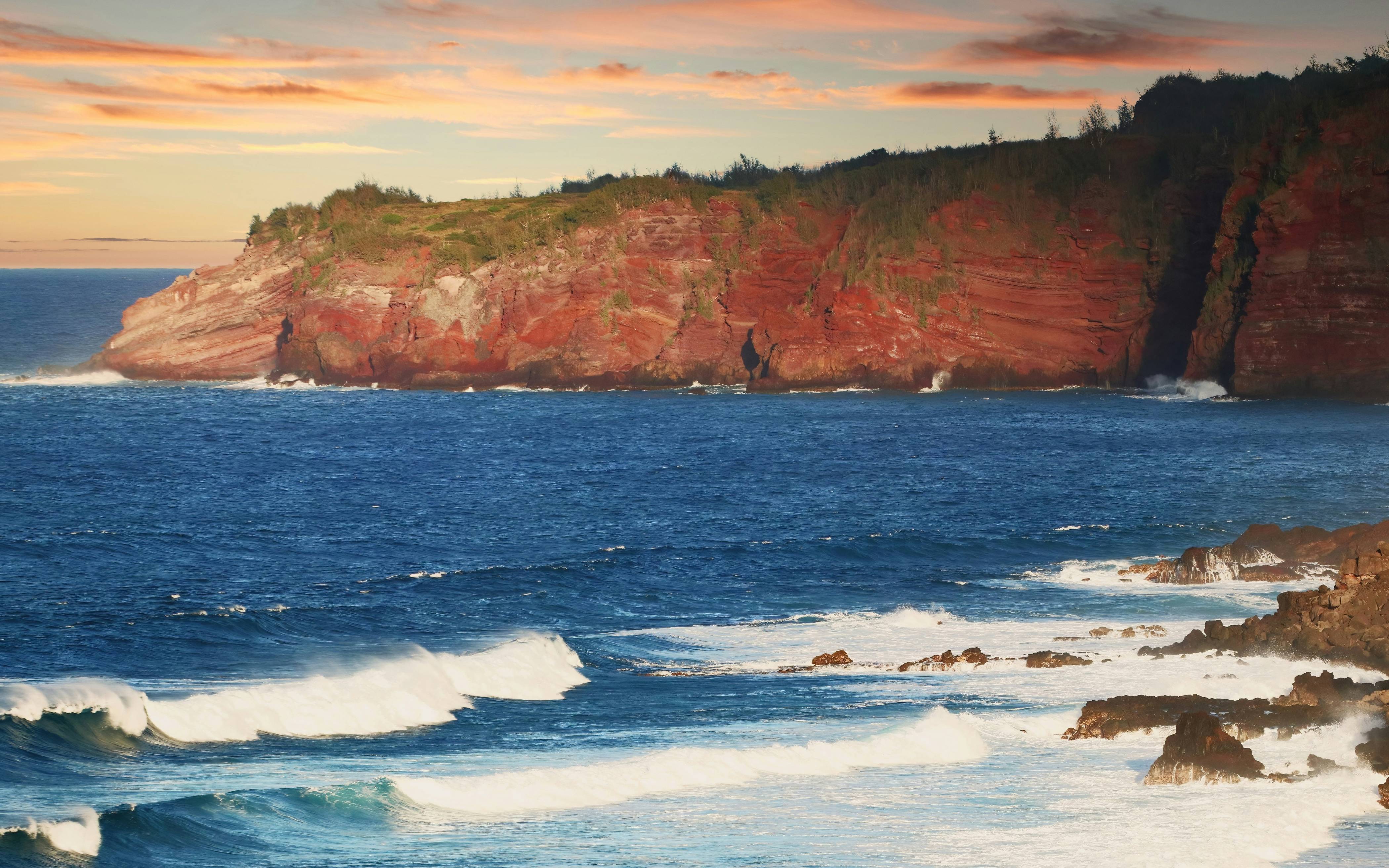a rocky cliff next to the ocean